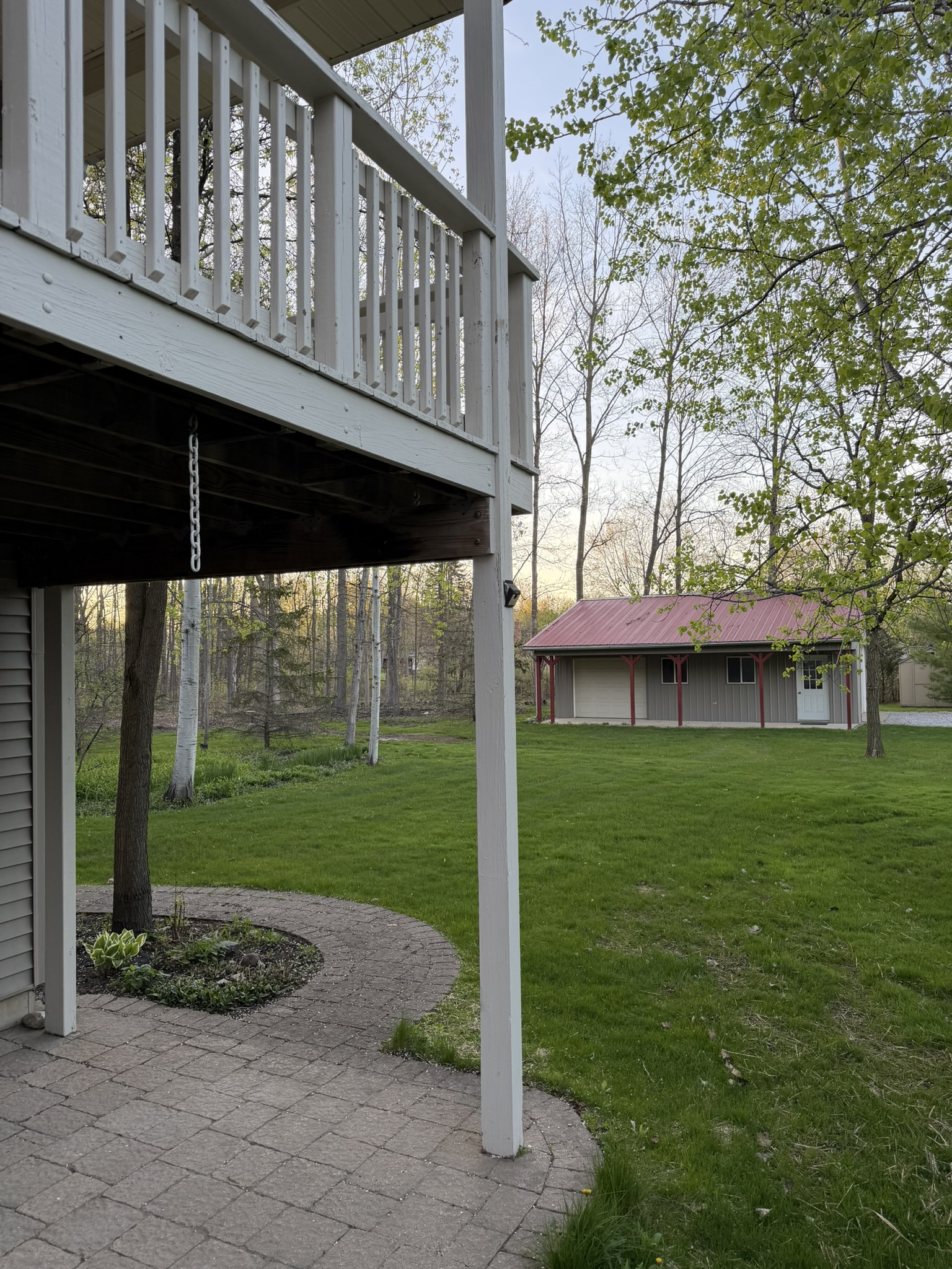 Brick patio and upper deck with pole barn view