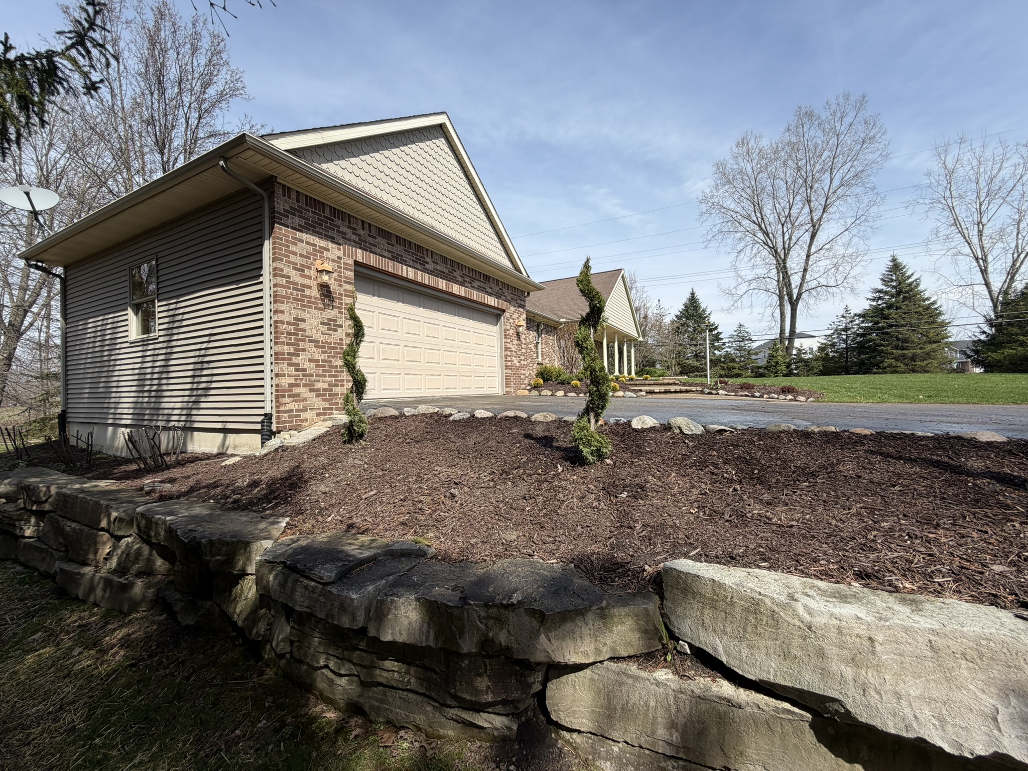 Front custom rock wall landscaping