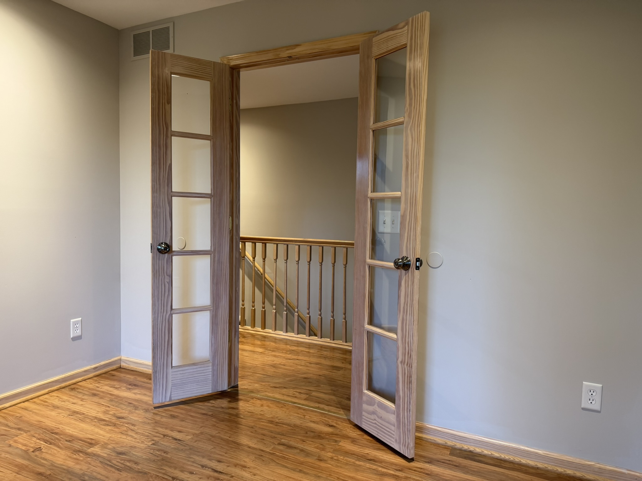 French doors opening to upper hallway and staircase